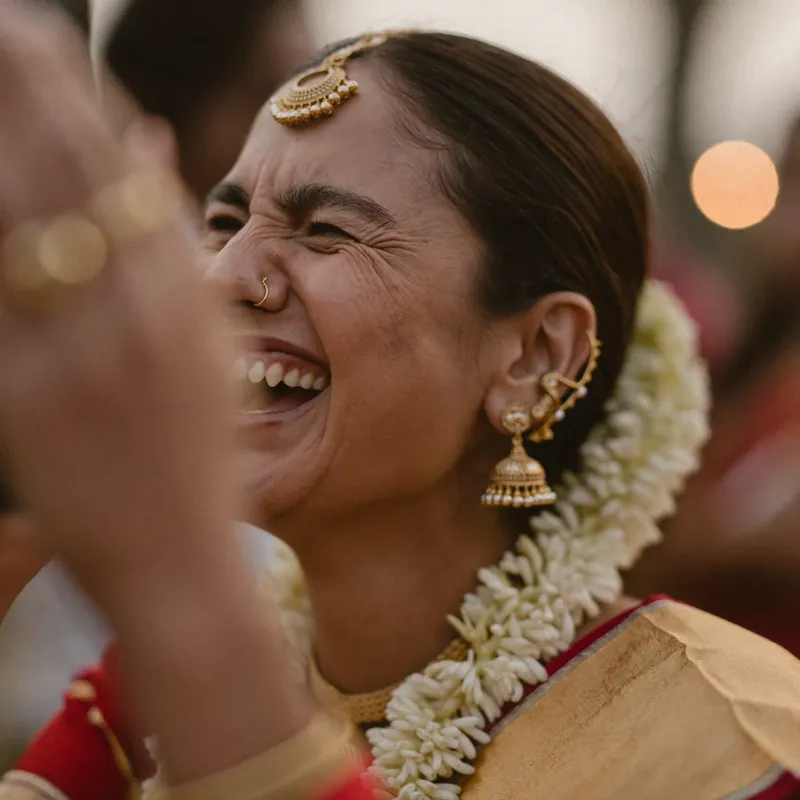 Laughing guest wearing a flower garland