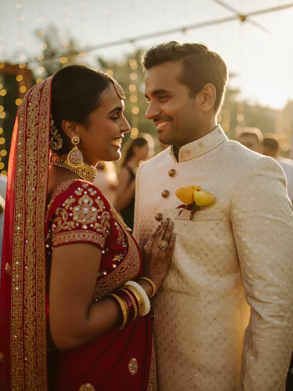 Bride and groom smiling together in warm daylight